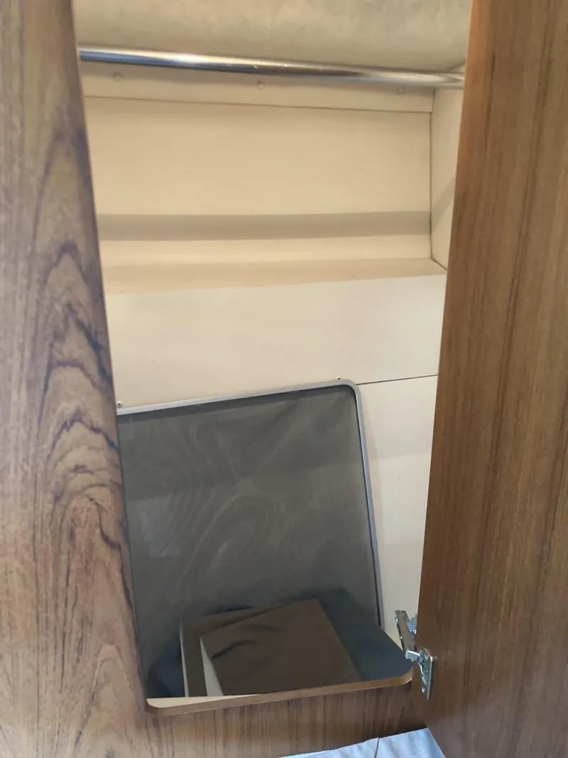 Slide: The Image of Interior storage compartment of 1996 Carver 320 Voyager boat with wooden finish. - 12