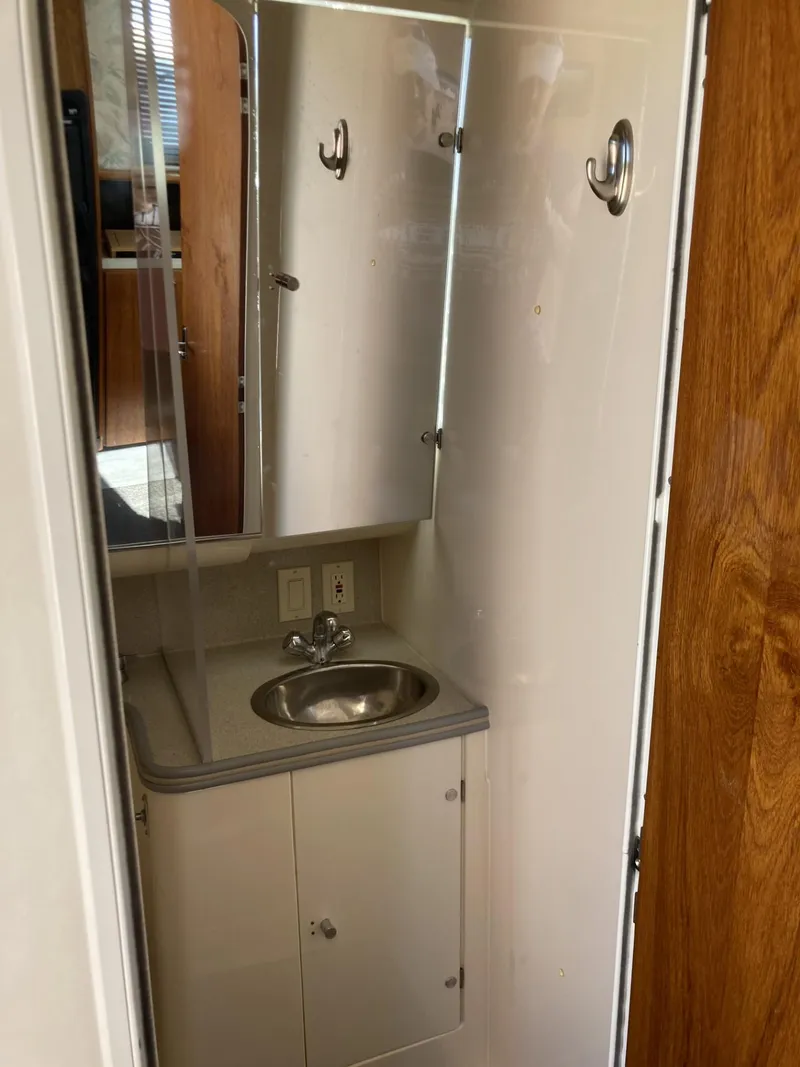 Slide: The Image of Bathroom interior of 1996 Carver 320 Voyager with sink and mirror cabinet. - 18