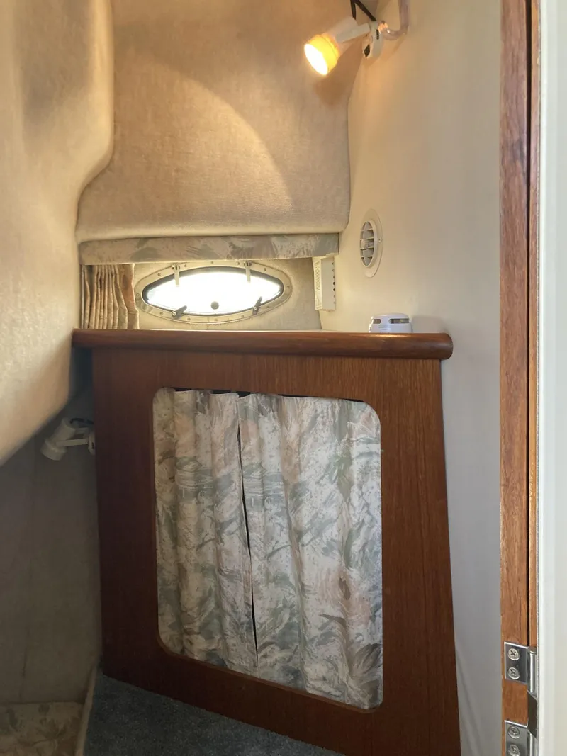 Slide: The Image of Interior cabin of 1996 Carver 320 Voyager with porthole and curtain. - 19