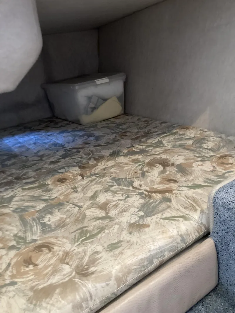 Slide: The Image of Interior cabin of 1996 Carver 320 Voyager with floral-patterned mattress and storage box. - 20