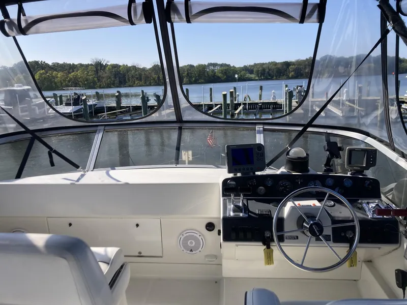 Slide: The Image of Interior view of 1996 Carver 320 Voyager boat cockpit with steering wheel and navigation equipment. - 21