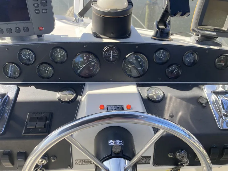 Slide: The Image of Dashboard of a 1996 Carver 320 Voyager boat with gauges and controls. - 22