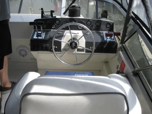 Slide: The Image of 1996 Carver 320 Voyager boat helm with steering wheel and control panel. - 4