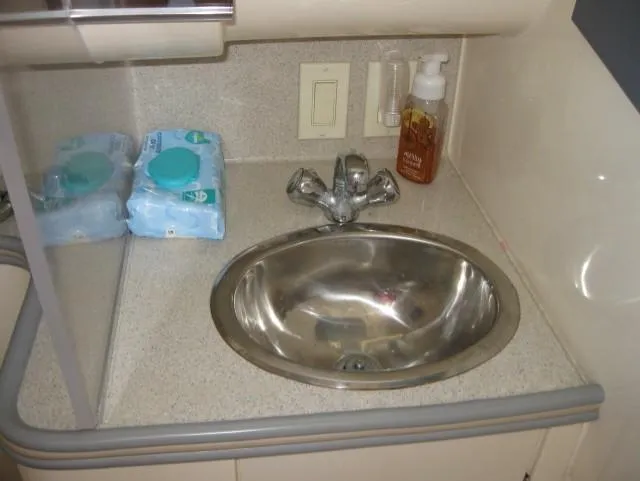 Slide: The Image of 1996 Carver 320 Voyager bathroom sink with faucet, soap, and wipes on countertop. - 7