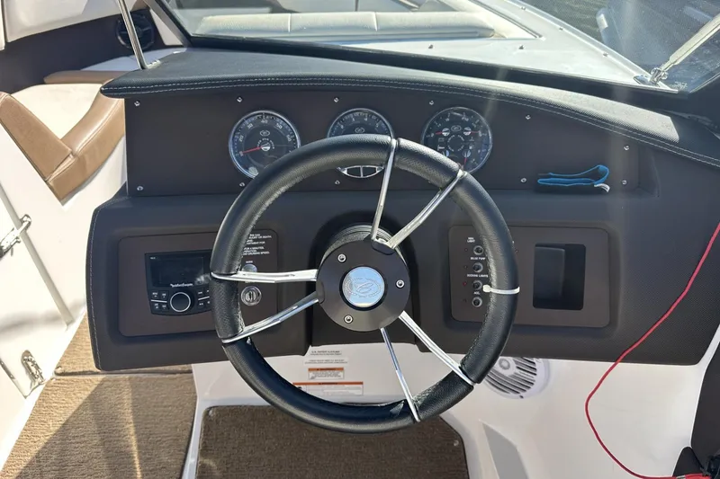 Slide: The Image of Steering wheel and dashboard of a 2018 Cobalt CS23 boat. - 12