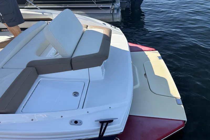 Slide: The Image of 2018 Cobalt CS23 boat with cushioned seating, docked on calm water. - 5