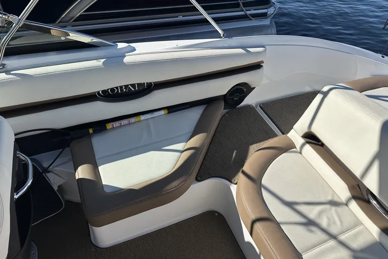 Slide: The Image of Interior of a 2018 Cobalt CS23 boat with cushioned seating and elegant design. - 7