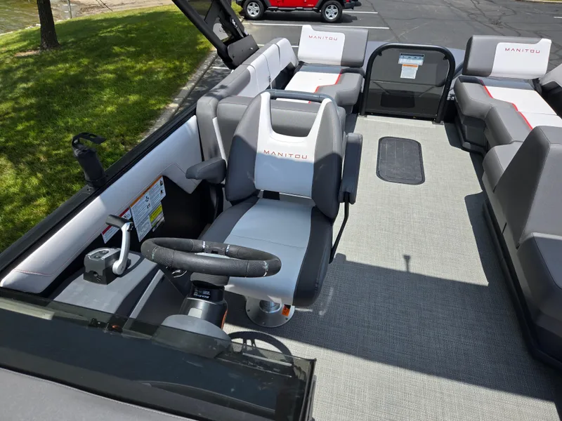 Slide: The Image of 2024 Manitou Cruise boat interior with steering wheel and seating arrangement. - 10