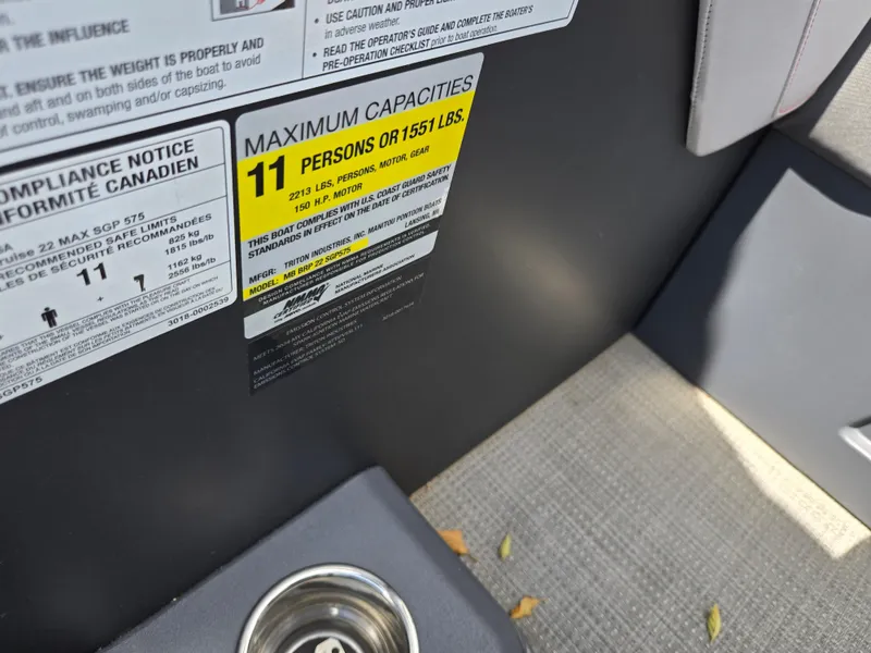 Slide: The Image of 2024 Manitou Cruise boat capacity label, seating for 11, maximum weight 1551 lbs. - 11