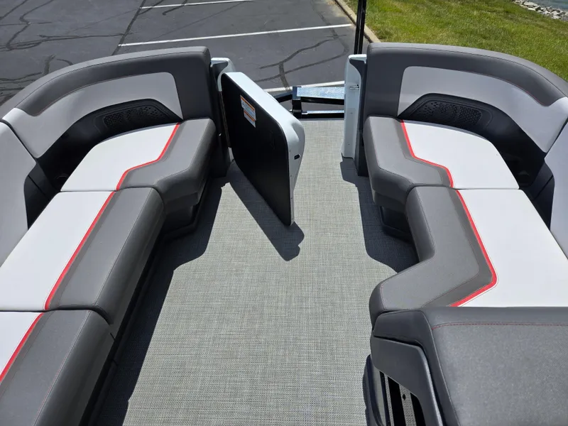 Slide: The Image of 2024 Manitou Cruise boat interior with gray seating and red accents. - 18