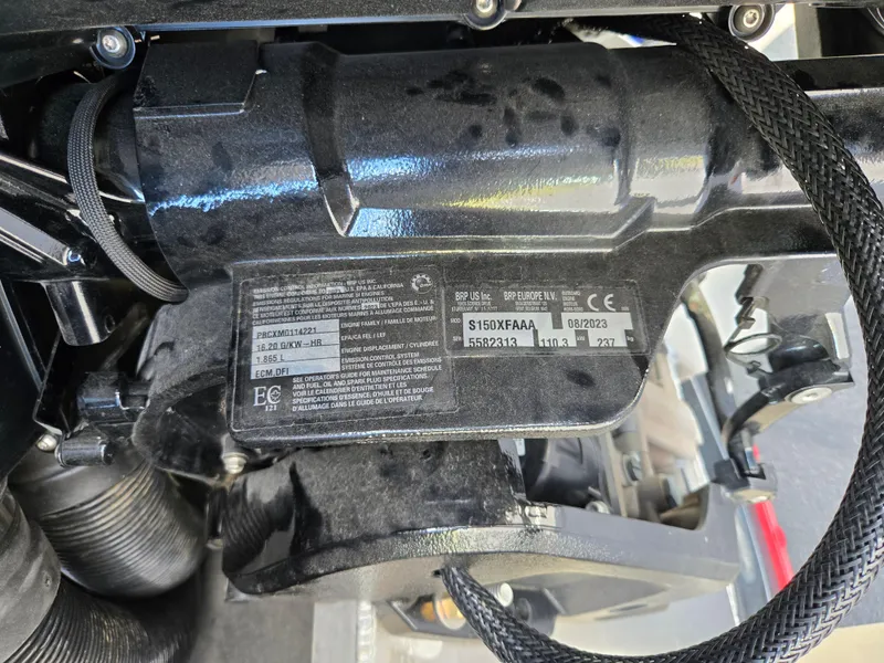 Slide: The Image of Close-up of a 2024 Manitou Cruise engine component with visible labels and wiring. - 21