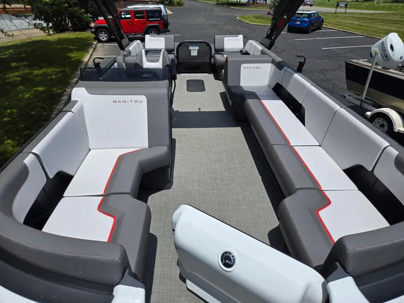 Slide: The Image of 2024 Manitou Cruise pontoon boat interior with spacious seating and modern design. - 9