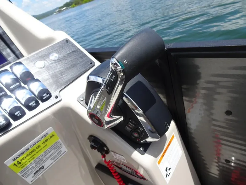 Slide: The Image of Control panel of 2023 Harris Sunliner 250 boat with throttle lever and switches. - 17