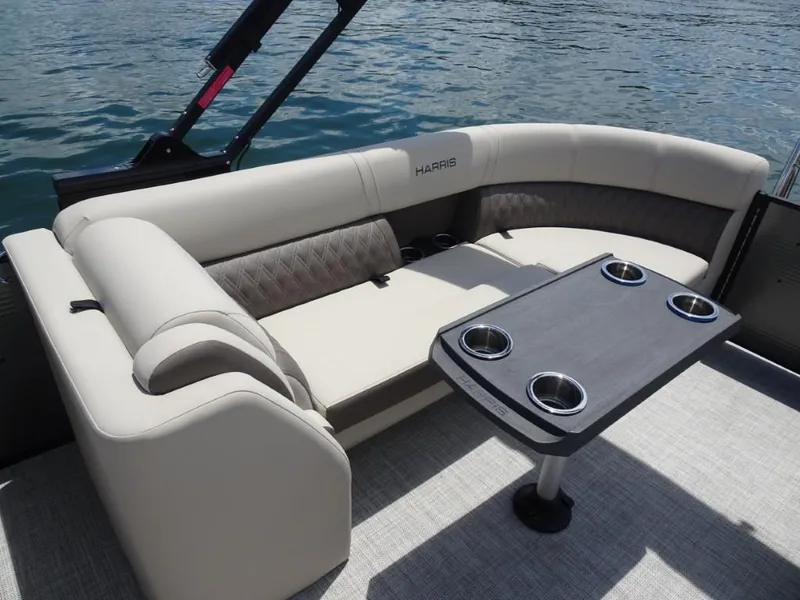 Slide: The Image of Luxurious seating area on 2023 Harris Sunliner 250 boat with table and cup holders. - 26