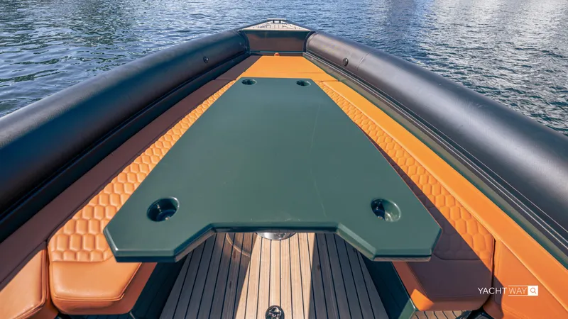 Slide: The Image of 2025 Skipper-BSK 38 boat deck with orange seating and green table on water. - 36