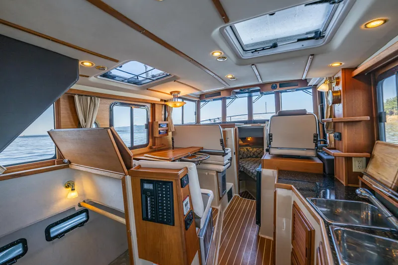 Slide: The Image of Interior of 2014 Ranger Tugs R-31CB boat with wood accents and modern amenities. - 15