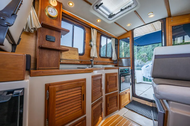 Slide: The Image of Interior of 2014 Ranger Tugs R-31CB boat with wood cabinetry and seating. - 19