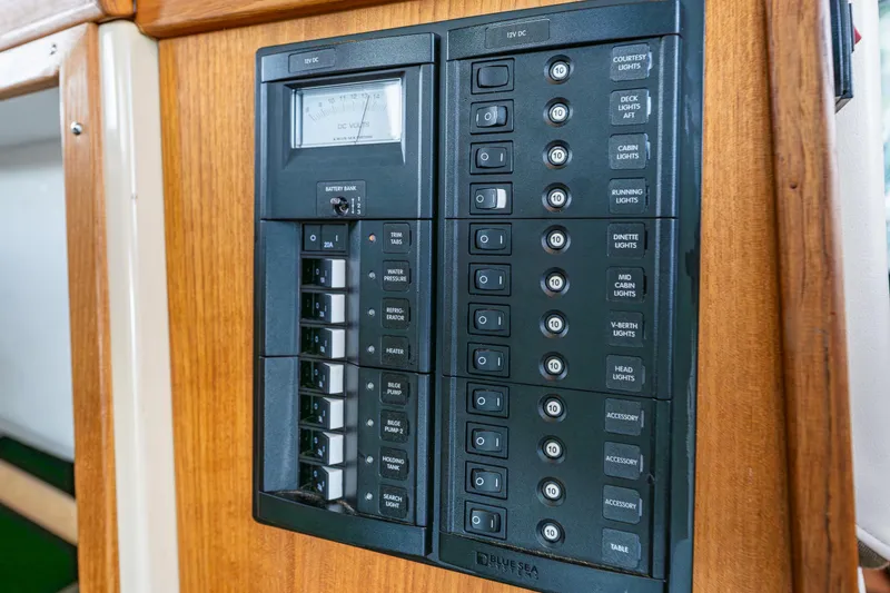 Slide: The Image of Electrical control panel on 2014 Ranger Tugs R-31CB boat, featuring various switches and gauges. - 26