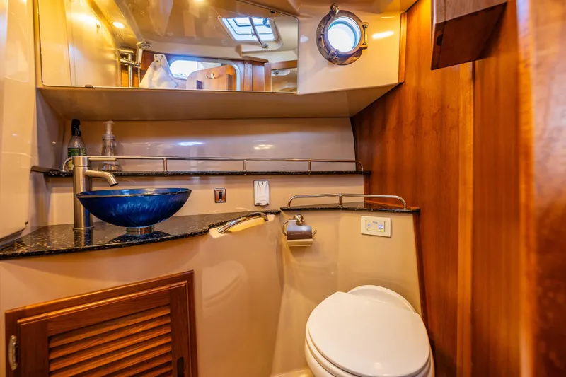Slide: The Image of Luxurious 2014 Ranger Tugs R-31CB bathroom with modern sink and wooden accents. - 31