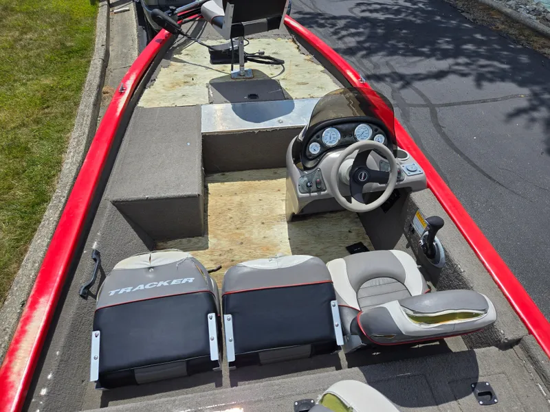 Slide: The Image of 2004 Tracker Pro Team 175 boat interior with steering wheel and seats. - 10