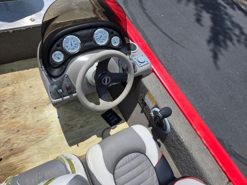 Slide: The Image of 2004 Tracker Pro Team 175 boat dashboard with steering wheel and gauges. - 11