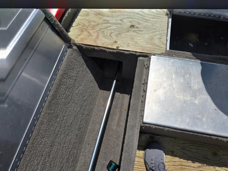 Slide: The Image of 2004 Tracker Pro Team 175 boat interior with storage compartments and carpeted flooring. - 15