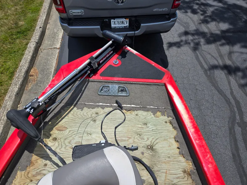 Slide: The Image of 2004 Tracker Pro Team 175 boat with trolling motor, parked behind a truck. - 16