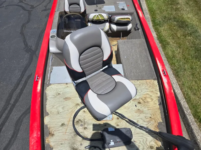 Slide: The Image of 2004 Tracker Pro Team 175 boat interior with gray seats and red trim. - 17