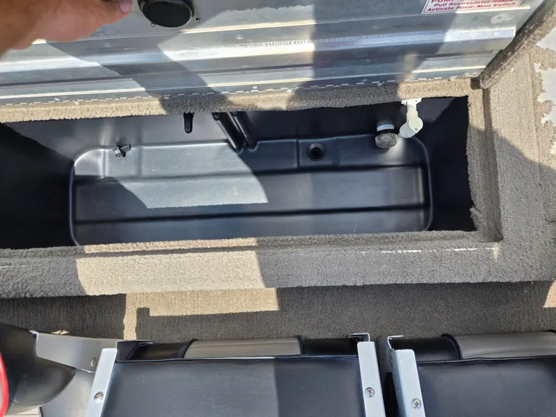 Slide: The Image of 2004 Tracker Pro Team 175 boat storage compartment with carpeted interior and seating. - 21