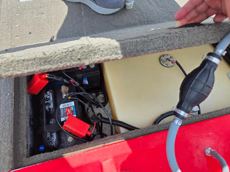 Slide: The Image of 2004 Tracker Pro Team 175 boat battery compartment with visible wiring and fuel tank. - 22