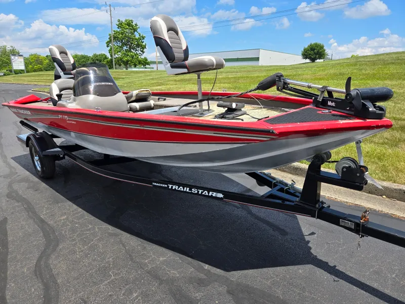 Slide: The Image of 2004 Tracker Pro Team 175 boat on trailer, red and silver, parked on asphalt. - 5