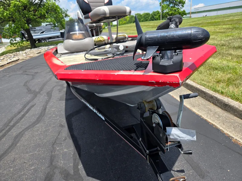 Slide: The Image of 2004 Tracker Pro Team 175 boat on trailer, red trim, parked on asphalt, sunny day. - 6