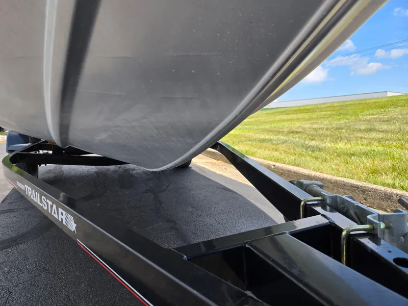 Slide: The Image of 2004 Tracker Pro Team 175 boat on a Trailstar trailer, parked on pavement. - 7