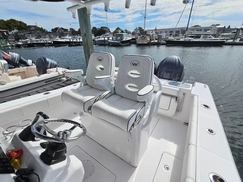 Slide: The Image of 2022 Southport 27 FE boat with dual seats, docked in a marina. - 10