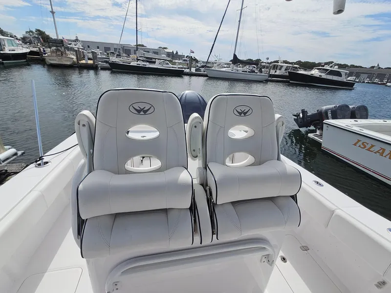 Slide: The Image of 2022 Southport 27 FE boat with dual white seats docked in a marina. - 11