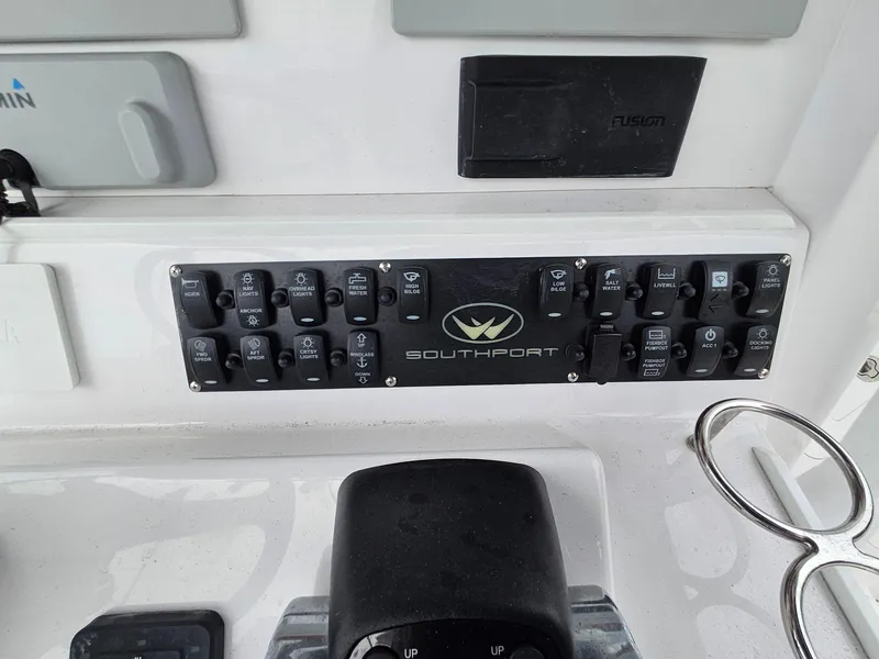 Slide: The Image of Control panel of a 2022 Southport 27 FE boat with labeled switches and logos. - 14