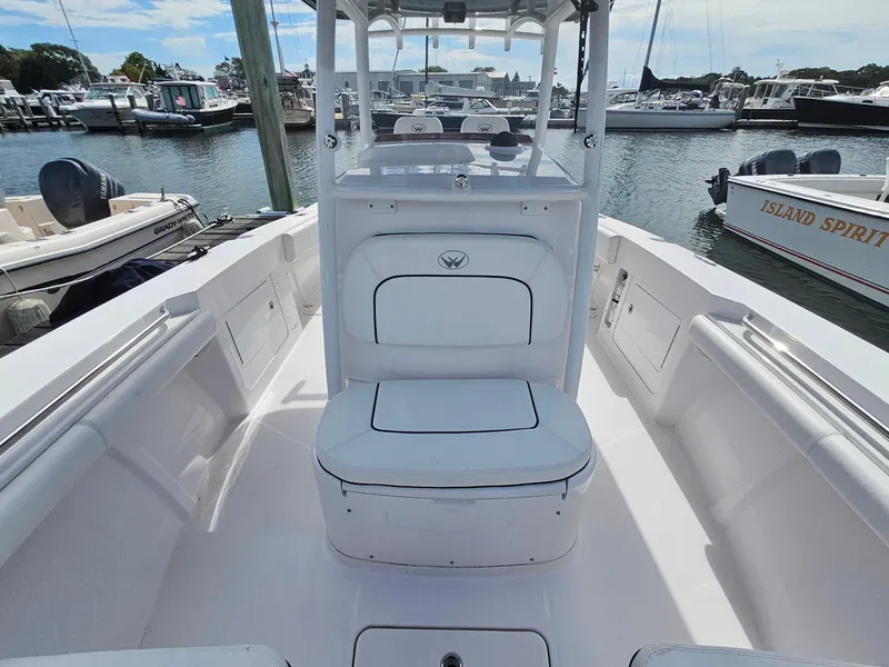 Slide: The Image of 2022 Southport 27 FE boat interior at marina, featuring seating and console. - 15