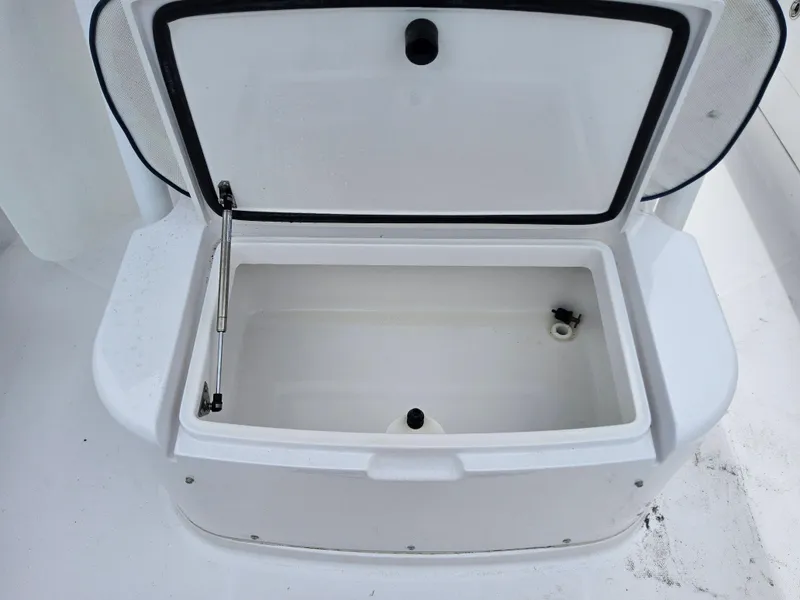 Slide: The Image of Open storage compartment on a 2022 Southport 27 FE boat. - 16