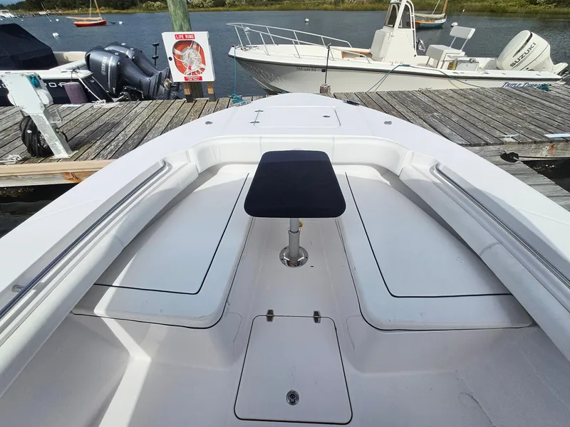 Slide: The Image of 2022 Southport 27 FE boat interior with table, docked by the water. - 17