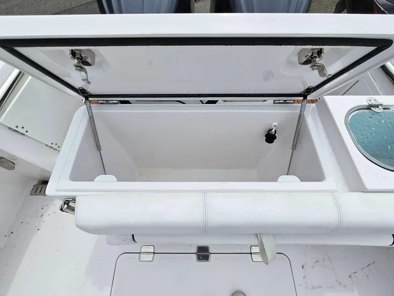 Slide: The Image of Open storage compartment on a 2022 Southport 27 FE boat, showcasing interior space. - 5