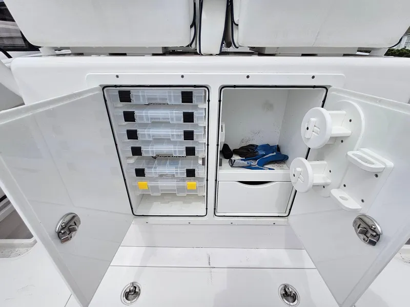 Slide: The Image of 2022 Southport 27 FE boat storage compartments with tackle boxes and gear. - 9