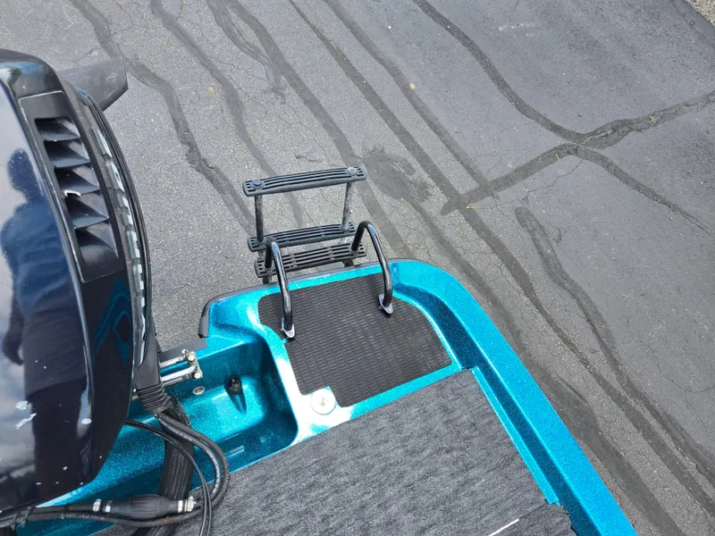 Slide: The Image of 1994 Hydra-Sports 175 FS boat with motor and ladder on asphalt surface. - 23