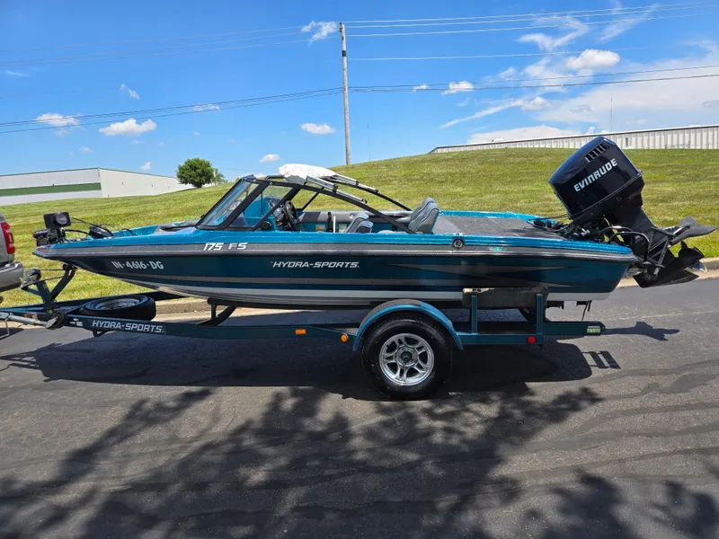Slide: The Image of 1994 Hydra-Sports 175 FS boat on trailer with Evinrude motor, parked outdoors. - 4