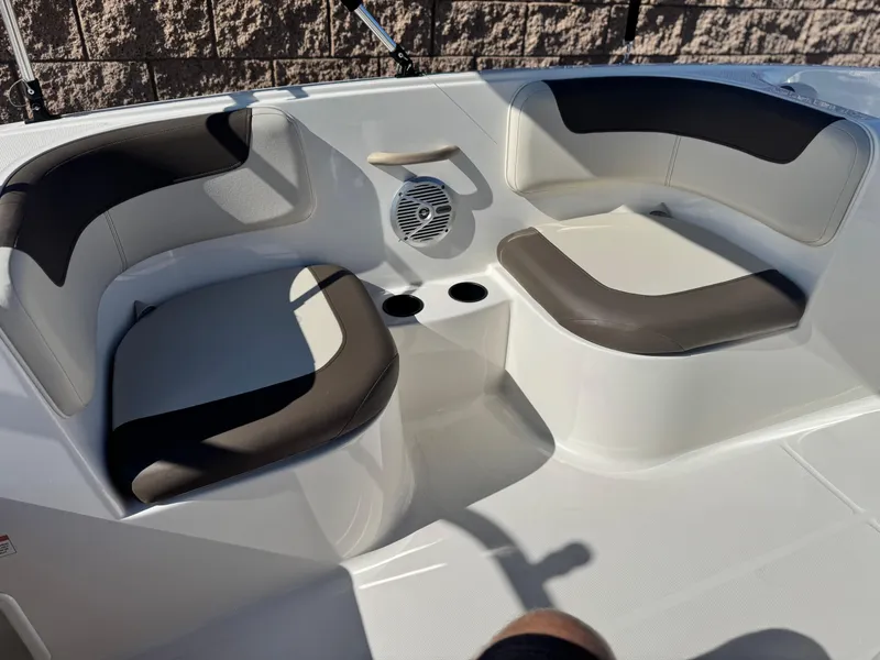 Slide: The Image of 2019 Bayliner Element E16 boat interior with cushioned seating and cup holders. - 12