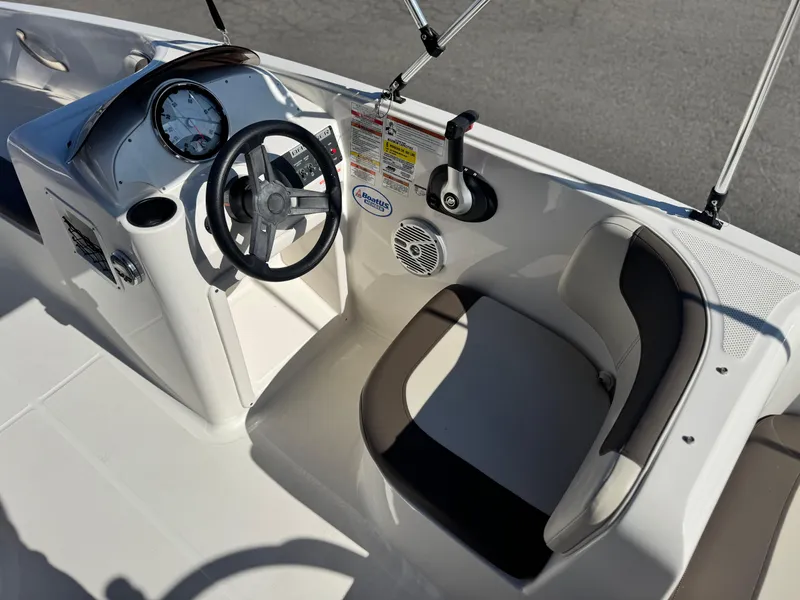 Slide: The Image of 2019 Bayliner Element E16 boat cockpit with steering wheel and seating. - 14