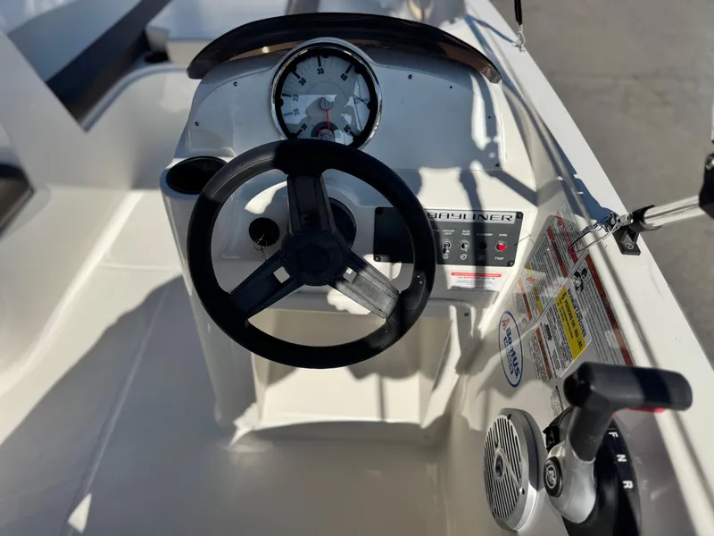 Slide: The Image of 2019 Bayliner Element E16 dashboard with steering wheel and control panel. - 15