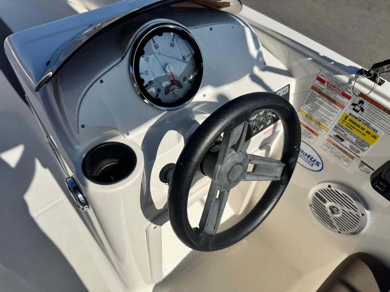 Slide: The Image of 2019 Bayliner Element E16 dashboard with steering wheel and gauges. - 16