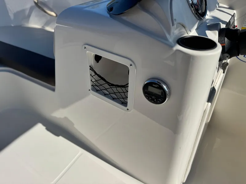 Slide: The Image of 2019 Bayliner Element E16 boat dashboard with storage compartment and control panel. - 17