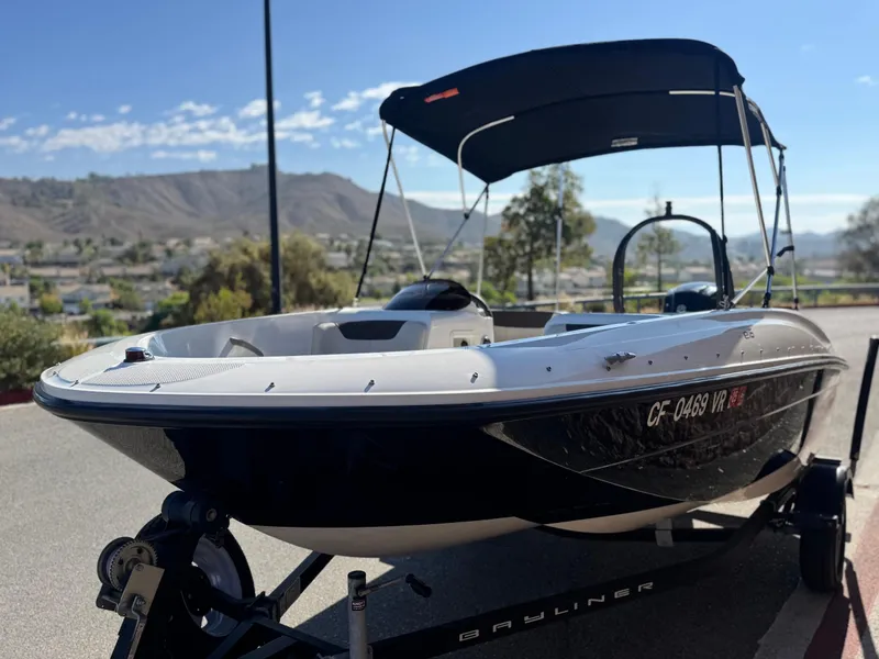 Slide: The Image of 2019 Bayliner Element E16 boat on trailer, scenic mountain backdrop. - 3
