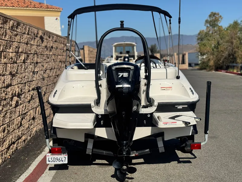 Slide: The Image of 2019 Bayliner Element E16 boat with 75 HP engine, parked on a sunny day. - 4